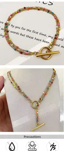 Detail of 18K gold plated multi-layer necklace with colorful beads and OT toggle clasp