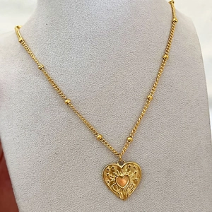French style gold heart pendant necklace with sunburst texture and star embossing details