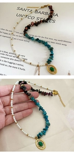 Detail of natural gravel pearls necklace with green gemstone oval pendant on gold setting