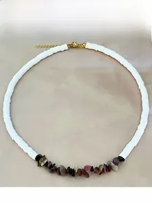Macro detail of bohemian beaded necklace with white clay beads and irregular gemstones
