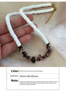 Ethnic choker necklace with white clay discs and colorful natural stone beads on silk background