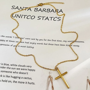 Minimalist gold double layer star and cross pendant necklace on white background