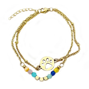 Double-layered gold bracelet with a hollow paw print pendant and vibrant colorful beads