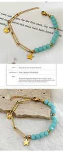 Detailed view of stainless steel bracelet with blue beads and star charms, 16cm length