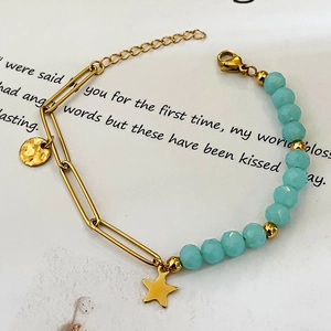 Gold-plated stainless steel bracelet with blue beads and star pendant on artistic base
