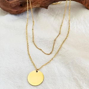 Elegant double-layered gold chain necklace with smooth circular pendant and small bead charms