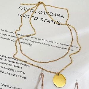 Minimalist gold double layer necklace with a polished round disc pendant for women