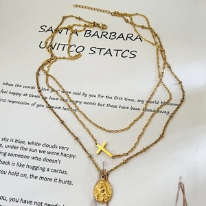 Layered 18k gold plated stainless steel necklace with cross and Virgin Mary medallion