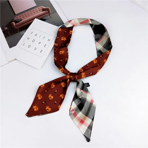 Detail of double-sided silk-like twilly scarf with cartoon cat and classic plaid patterns