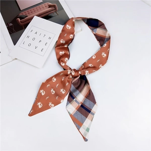 Detail of cartoon cat pattern and plaid texture on a slim silk scarf for women