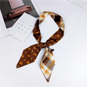 Detailed view of double-sided scarf with cartoon cats and classic plaid patterns