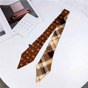 Detailed view of a double-sided twilly scarf featuring cute cat patterns and classic plaid