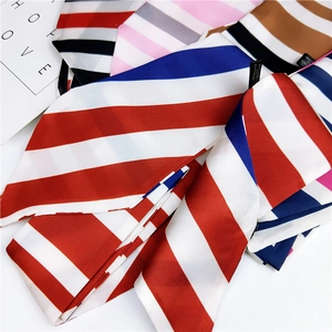 Detailed view of colorful twill striped narrow scarves with silk-like texture and fine stitching