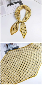 Détail d'un foulard plissé à motifs géométriques losanges en soie jaune et noire