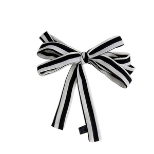 Elegant black and white striped bow scarf hair accessory with a minimalist vintage style