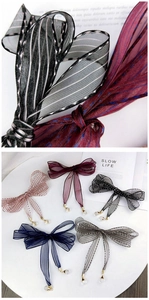 Close-up of sheer striped ribbon bows with crystal pendants in multiple colors