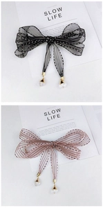 Detail of striped ribbon with crystal drop pendants in black and pink elegant designs