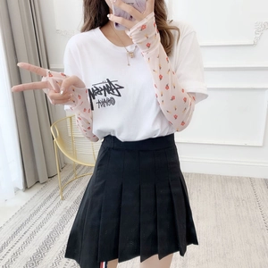 Detail of pink floral mesh arm sleeves paired with a stylish graphic t-shirt and skirt