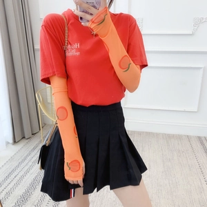 Detail of orange mesh sun protection arm sleeves with peach pattern and sheer texture