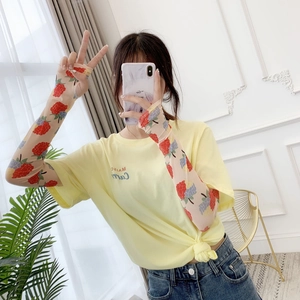 Detailed view of floral strawberry mesh sun protection arm sleeves for summer UV protection