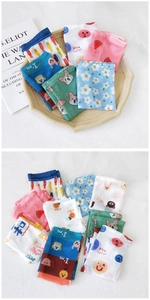 Detailed view of sheer floral mesh arm sleeves with colorful cartoon animal prints