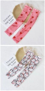 Close-up of mesh sun protection sleeves with watermelon and cute cartoon bear prints