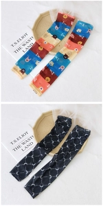 Detailed close-up of mesh arm sleeves featuring cute cartoon animal and crescent moon patterns