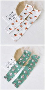Detail of mesh sun sleeves featuring cute orange and corgi prints for UV protection
