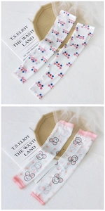 Detail of breathable ice silk arm sleeves featuring cute cartoon and polka dot prints