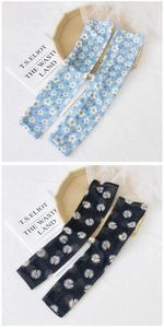 Detail of light blue and black ice silk sun sleeves with small daisy floral print