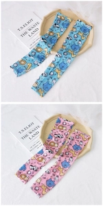 Detail of blue and pink ice silk sun sleeves with cartoon zoo animal prints