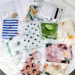 Assorted patterned mesh underwear in individual frosted zipper packaging on a table