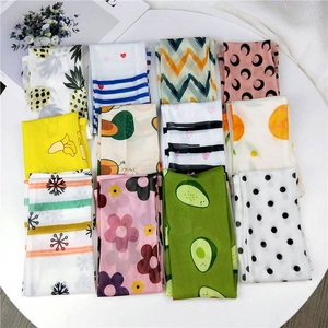 Detail of mesh sun protection sleeves with diverse fruit and crescent moon patterns