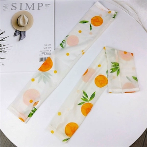 Detail of mesh sun protection sleeves with sweet orange and peach fruit patterns