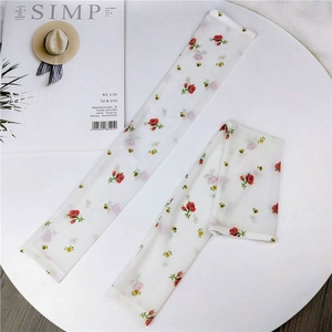 Close-up of floral mesh sun protection sleeves with red rose and yellow flower patterns