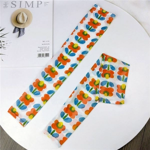 Close-up of lightweight floral mesh sun protection sleeves with orange flower patterns