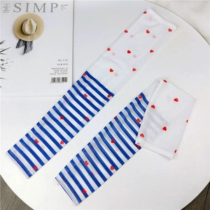 Detail of mesh sun protection sleeves with blue stripes and red heart patterns