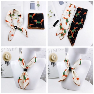 Detailed view of fox pattern neck scarves with elegant brown stitched edges and ring buckle