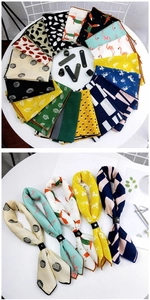 Detailed view of colorful printed square scarves with premium black leather slider rings
