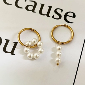 Modern asymmetric gold hoop earrings featuring geometric white pearl clusters and dangles