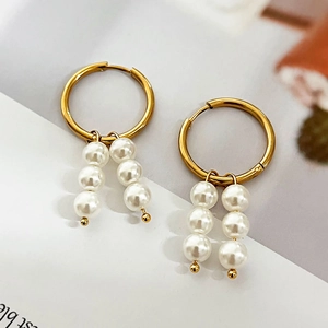 Elegant gold hoop earrings with double pearl pendants and minimalist geometric design