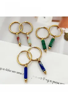 Detail of French style gold hoop earrings with colorful natural stone cylinder pendants