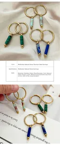 Detail of colorful natural stone pendants on stainless steel hoop earrings for women