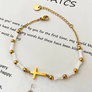 Luxurious gold stainless steel beaded bracelet with white bone charms and cross
