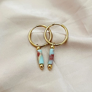 French style gold hoops with cylindrical natural stone charms on champagne silk background