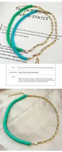Detail of beaded necklace with blue polymer clay discs and gold titanium steel chain