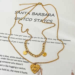 Retro gold-toned double-layer necklace with heart pendant and circular charms