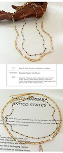 Collier double épaisseur en acier titane doré avec pendentif perle et émail bleu