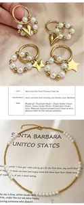 Detail of elegant gold-tone heart and star pearl jewelry set with layered necklace