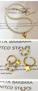 Detailed set of pearl necklace with gold heart pendant, matching ring and hoop earrings